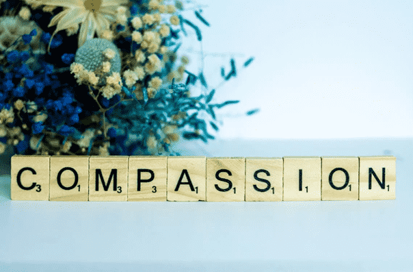 compassion written from scrabble pieces