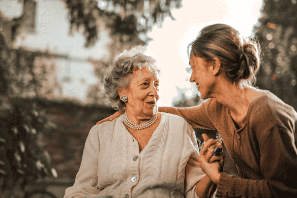 a person talking to an elderly lady