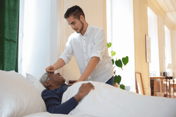 a person checking an elderly person’s temperature