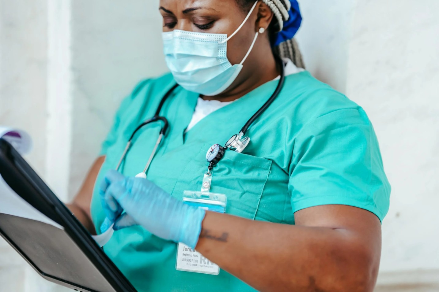 A nurse looking at a clipboard