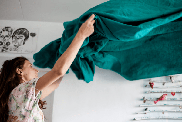 A woman holding a bedsheet