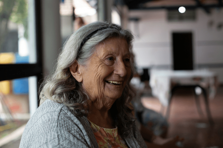 An elderly woman smiling