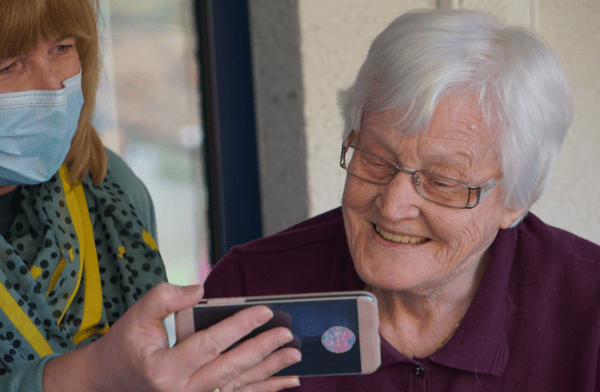  A nurse holding the phone up to a senior