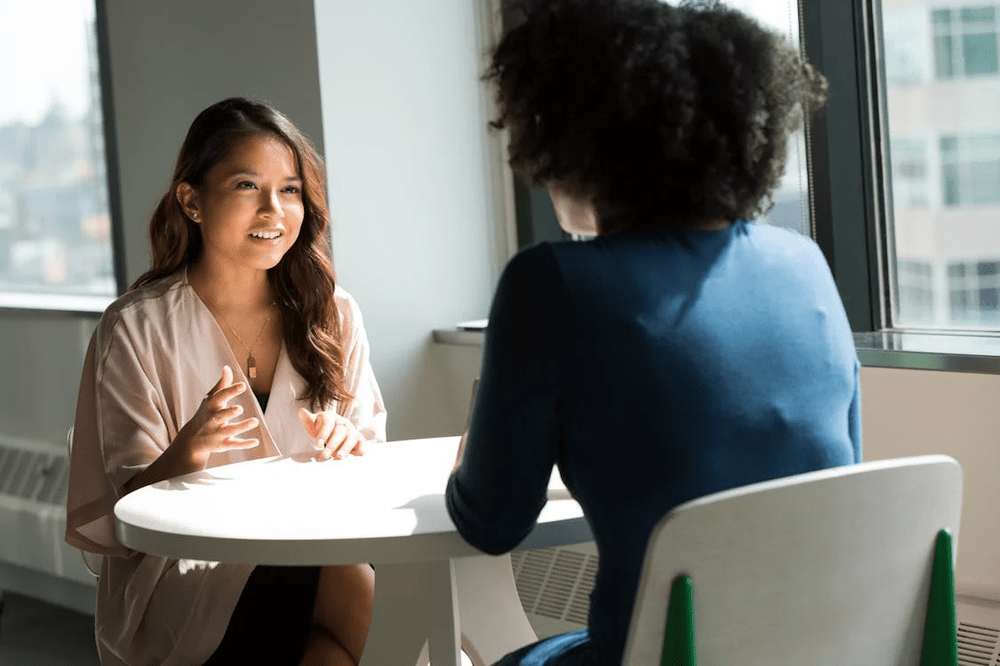 A dietitian discussing meal plans with a caregiver in a residential home