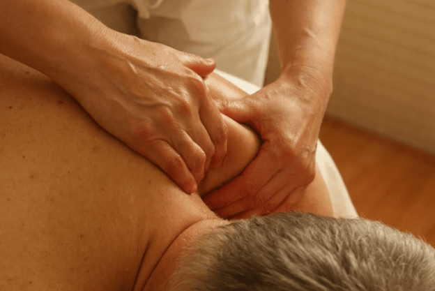 A physical therapist assisting a senior with exercises in a retirement village