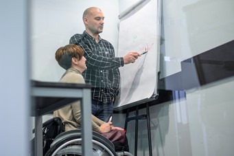 A picture of a support worker, helping a woman with a learning disability