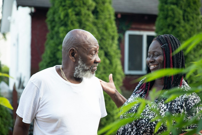 A picture of a support worker helping an old man