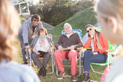 A picture of a support worker helping a group of senior citizens 