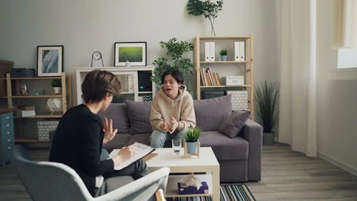 A long-term support worker having a one-to-one conversation with a boy in a children’s home, offering guidance and emotional support.