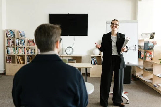 Support worker teaching a man with a learning disability at a care staffing agency.