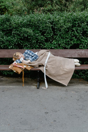woman sleeping on a bench