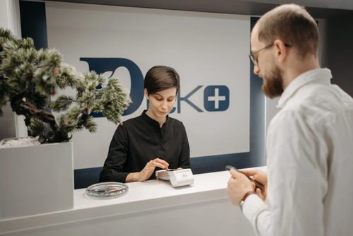 woman working behind the counter at a medical facility
