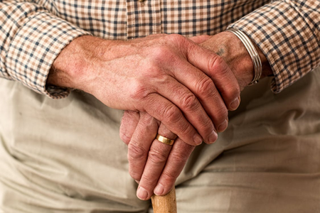 A close-up of an old man’s hands