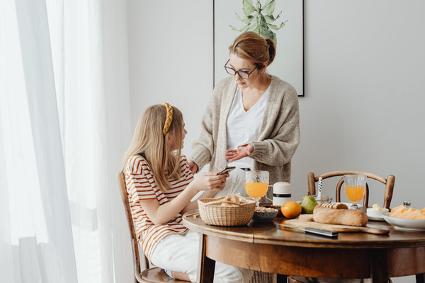 A caretaker talking to a teenager