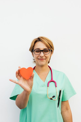 A support worker holding a paper heart