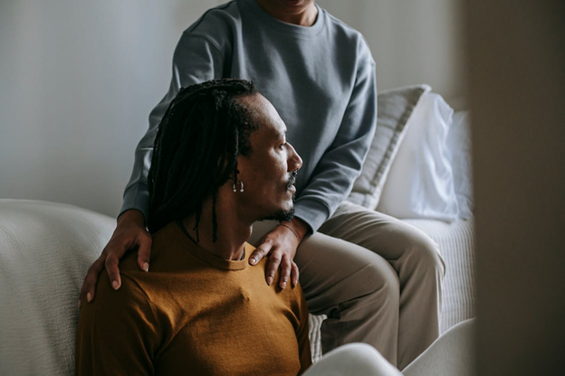 a support worker calmly comforting a resident in a care home setting