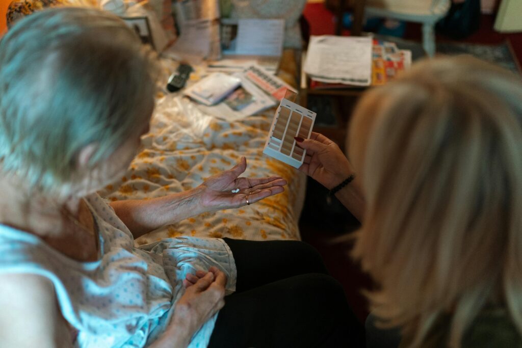 Support worker showing color shades to an elderly person