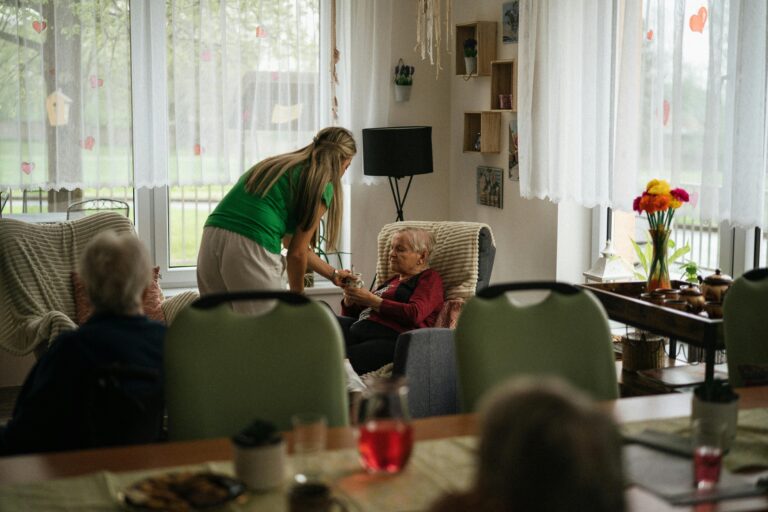 Support worker assisting elderly residents with daily care in a nursing home