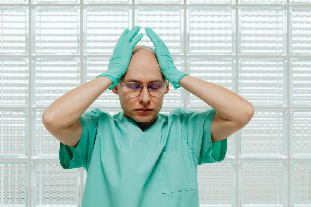 Support worker holding his head in stress while working in home health care