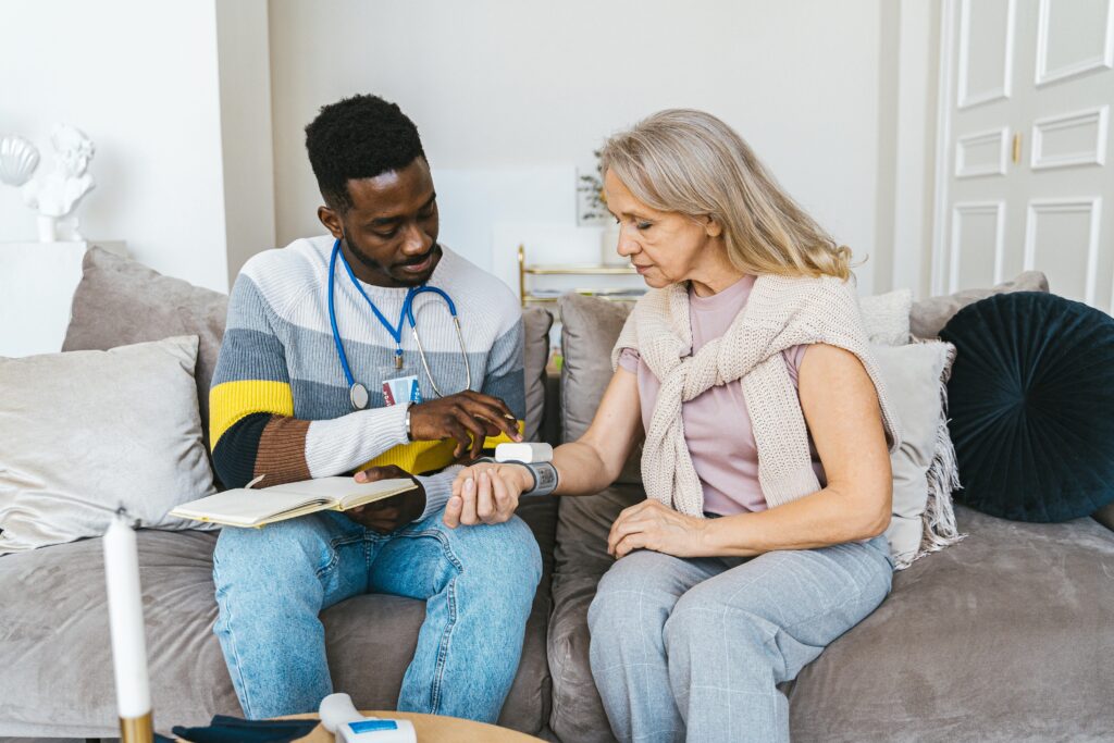 Support worker helping an elderly woman with daily activities in a care setting