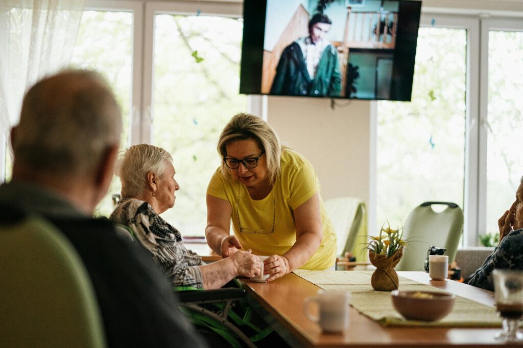 Support worker consoling an elderly woman 