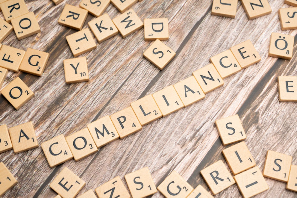 Compliance is written with scrabble tile.