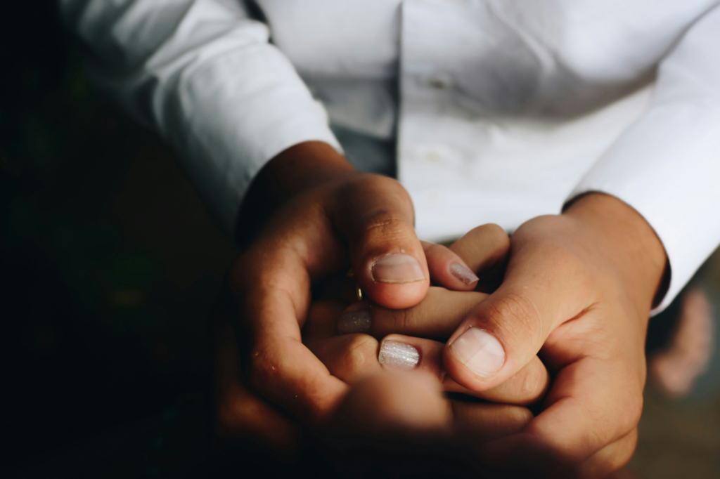 support worker gently holding a resident’s hand during care interaction