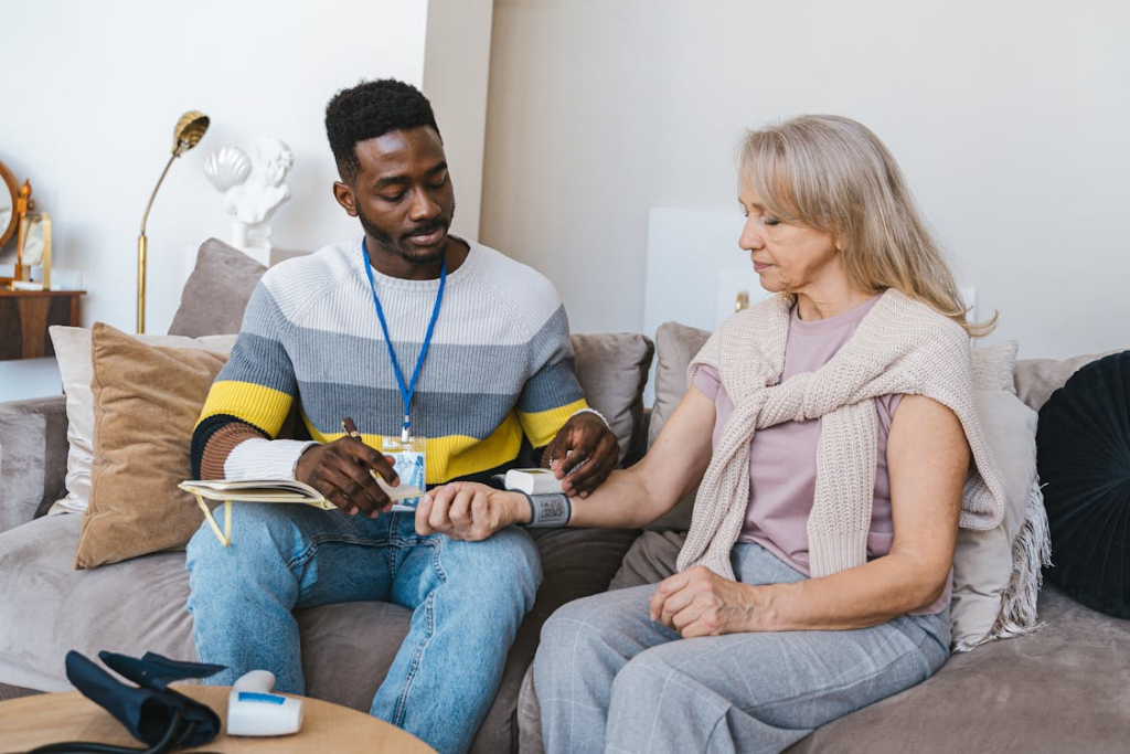 A person checking the blood pressure of another person 