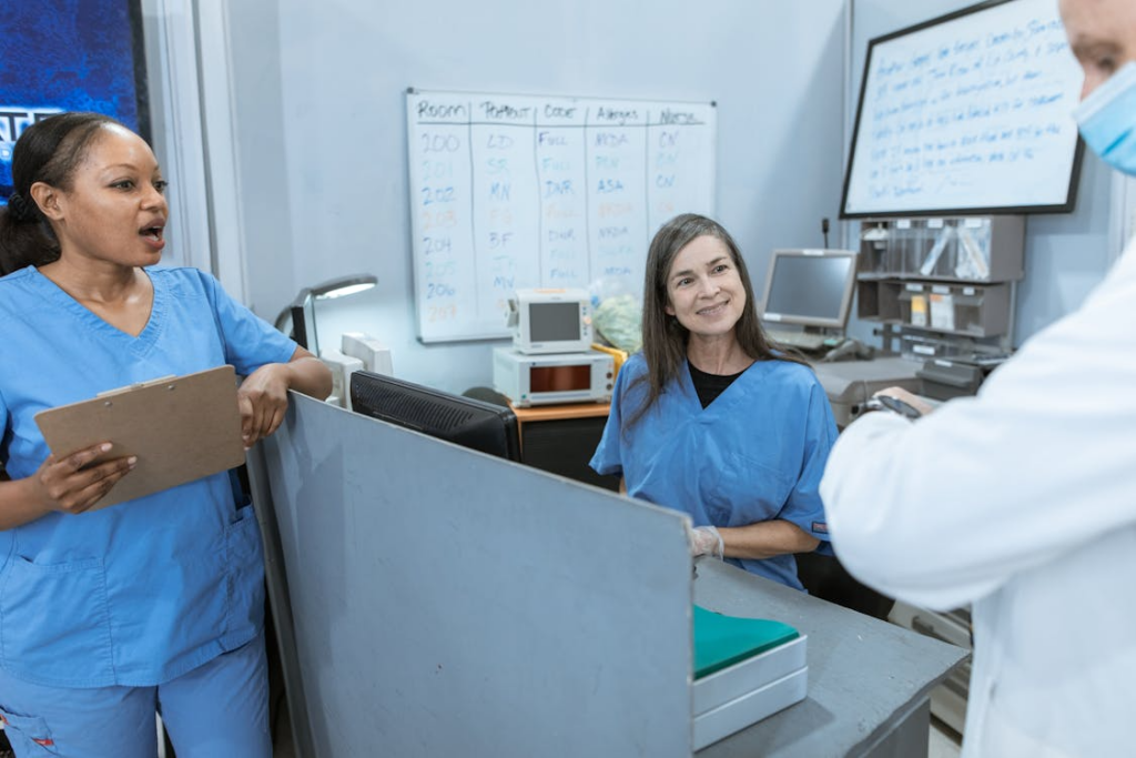 A group of people in scrubs talking 