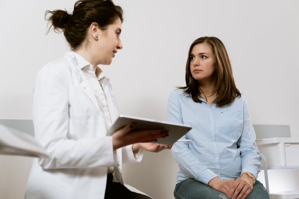 A person talking to another with a tablet