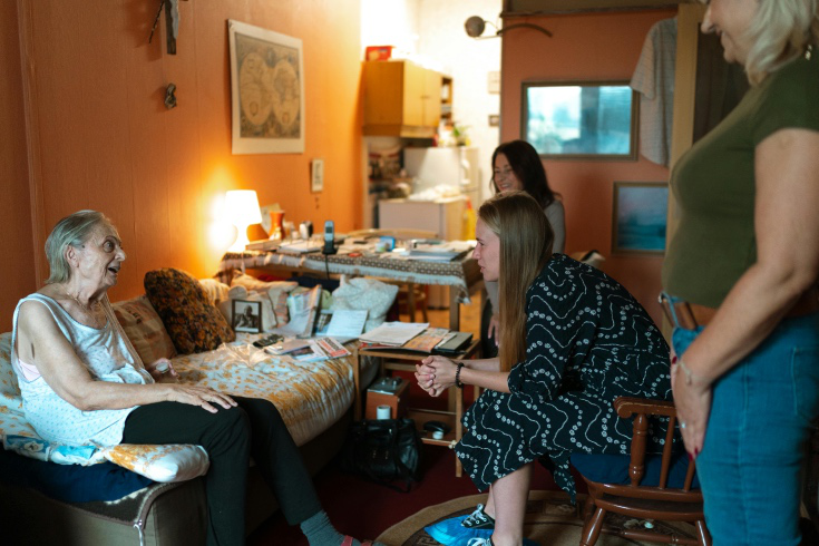 Family carer speaking with a professional support worker before respite care begins
