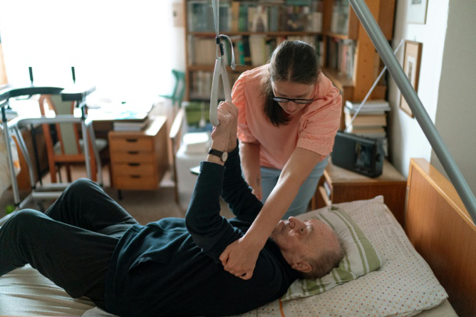 Support worker assisting a senior resident with daily activities at home