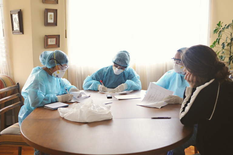 Care professionals reviewing client information during a team meeting