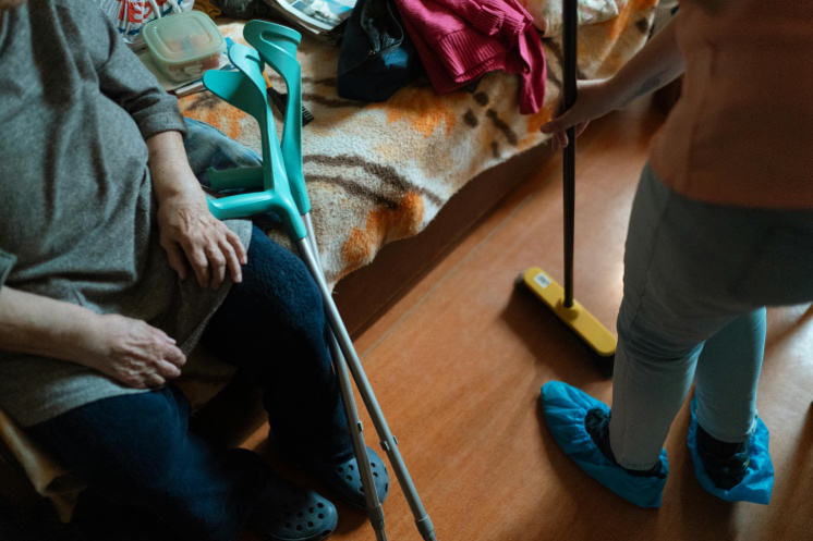 Support worker assisting a resident in a supported living setting