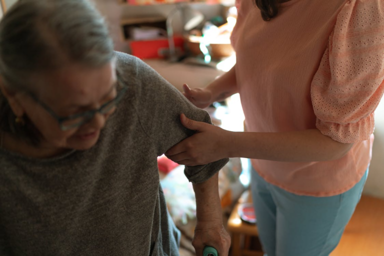 A support worker assisting a senior woman