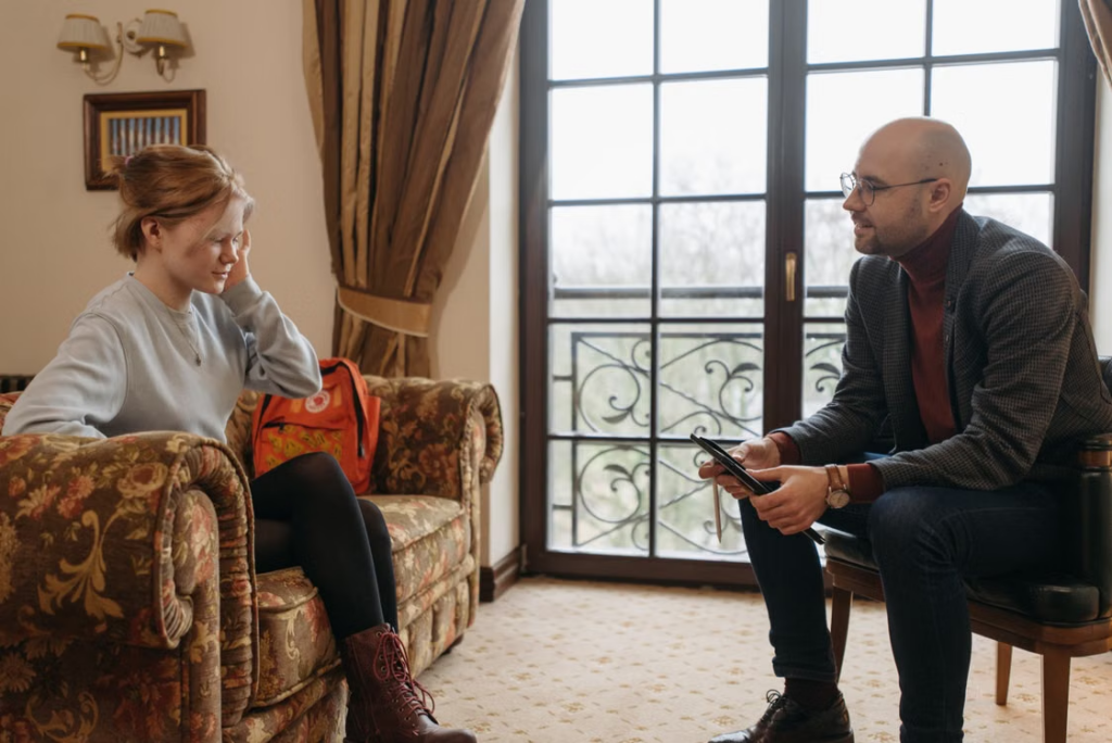 A professional support worker talking to a teen