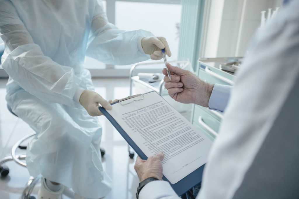 An image of a person handing a paper and pen to another person  