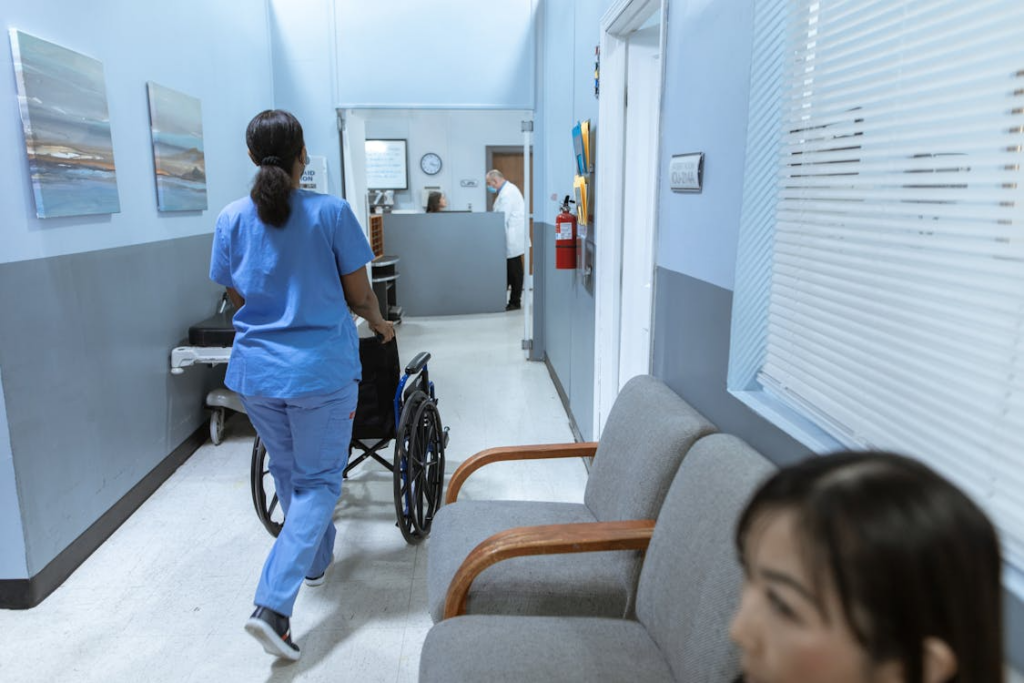 An image of a nurse pushing a wheelchair 