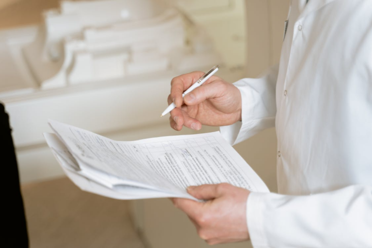 An image of a person holding a pen and a document
