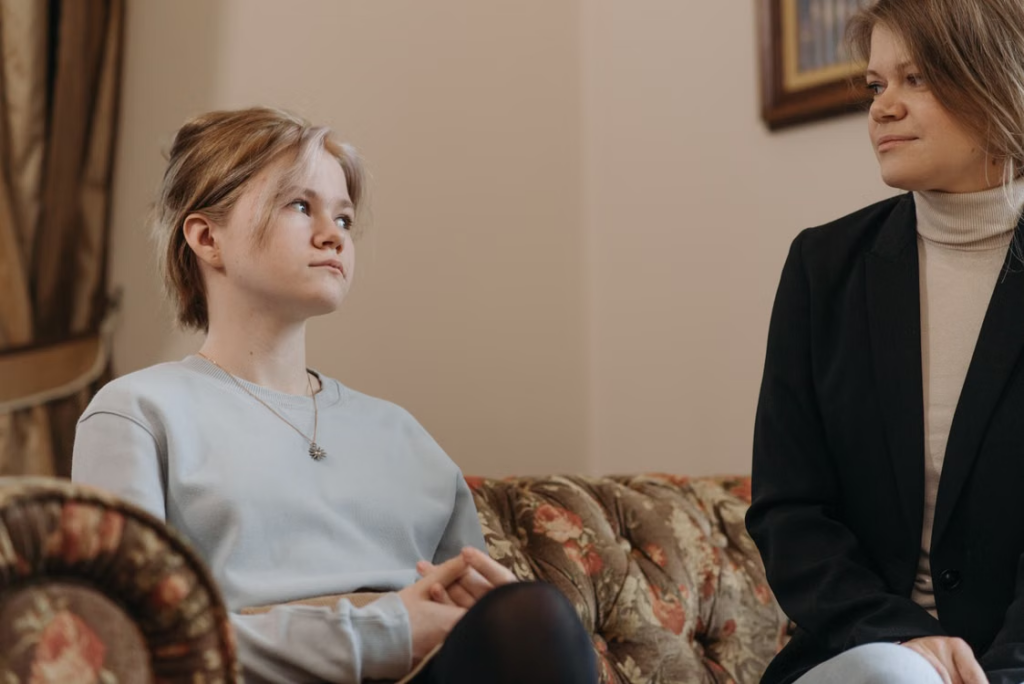 Residential childcare professional providing one-to-one emotional support to a young person.