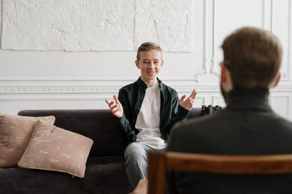 A person talking to a teen 