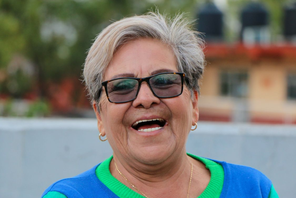 Happy older woman enjoying social wellbeing in a retirement village