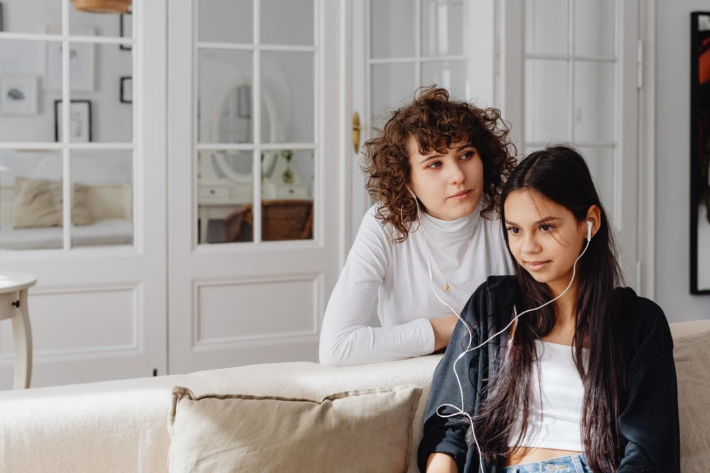 women sitting on a couch.