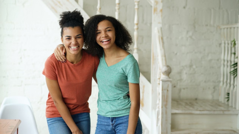 two girls standing in a modern interior space.