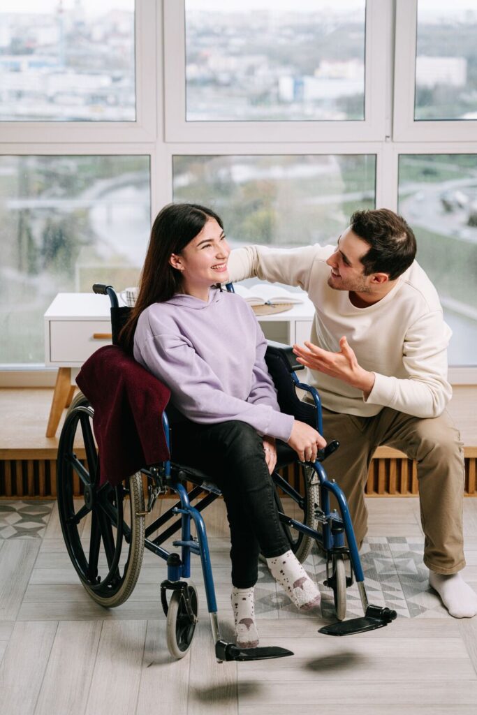 a caregiver and a young girl smiling together
